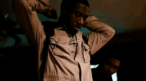 a man wearing a jacket that says s & b on it