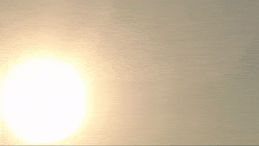the sun is shining brightly on a white wall .
