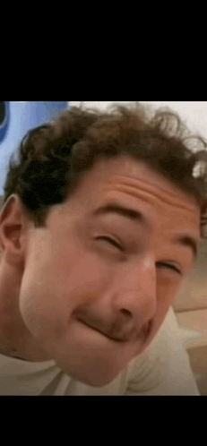 a man is making a funny face with his eyes closed