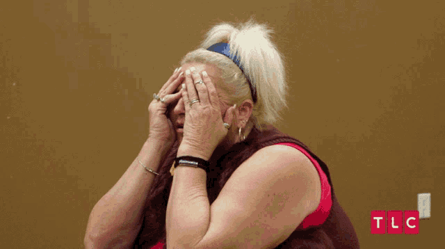 a woman covering her face with her hands with a tlc logo in the corner