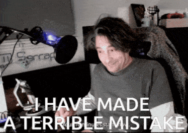 a man sitting in front of a microphone with the words " i have made a terrible mistake " above him