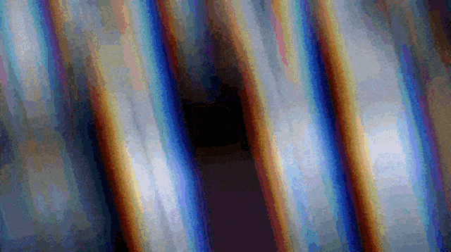 a pixelated image of a rainbow colored background