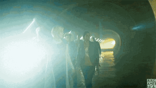 a group of people walking through a tunnel with the bbc america logo on the bottom