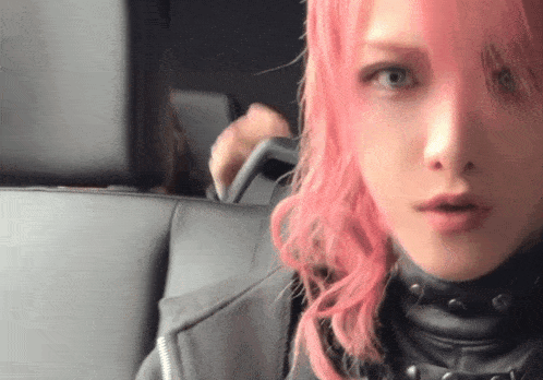 a woman with pink hair is sitting in a car