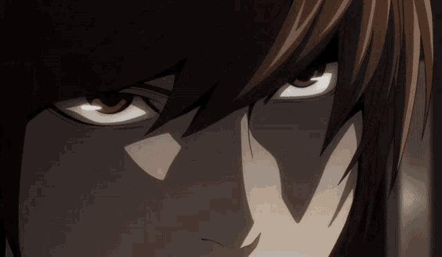 a close up of a person 's eyes with a shadow on the face