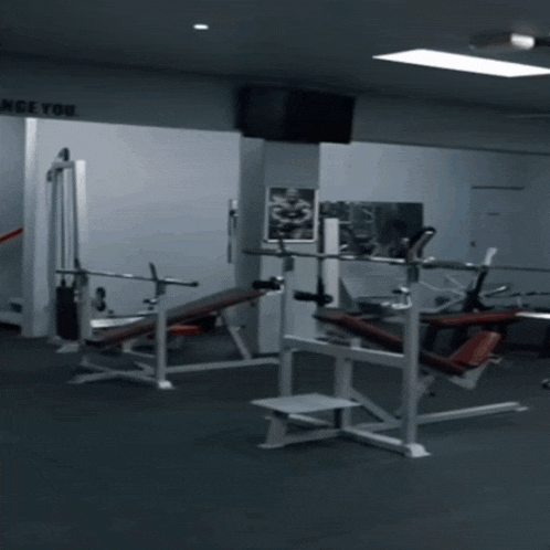 a man is running in a gym with a sign on the wall that says " once you "