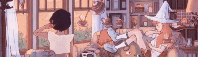 two women in witch hats are sitting on a couch in a living room .
