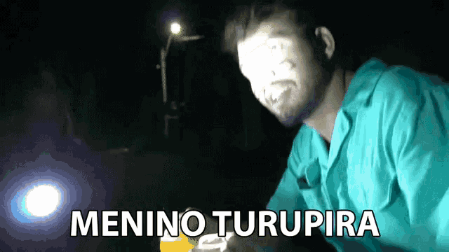 a man in a blue shirt with the words menino turupira written below him