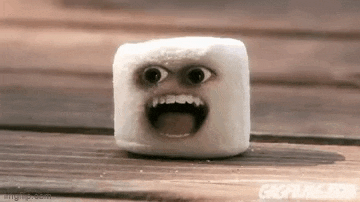 a marshmallow with a face on it is sitting on a table .