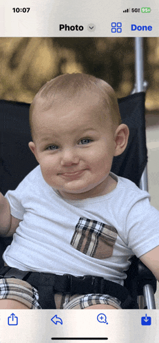 a baby is sitting in a stroller with the time 10:07 on the screen