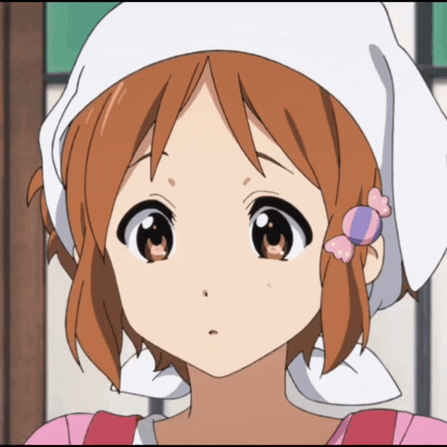 a close up of a girl wearing a pink apron and a white hat