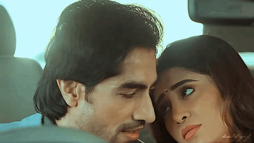 a man and a woman are kissing in the back seat of a car ..