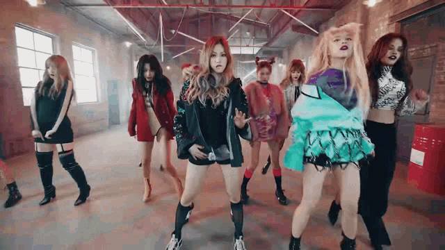 a group of women are dancing in a room .