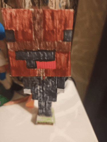 a minecraft figure made out of a piece of newspaper