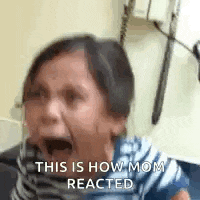 a little girl is crying and screaming in a hospital room while talking on a cell phone .