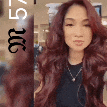 a woman with long red hair is standing in front of a sign that says ' 5 ' on it