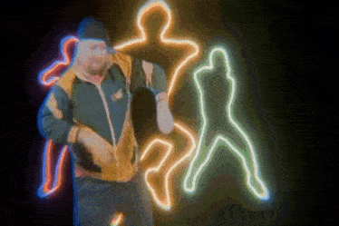a man dancing in front of a neon sign