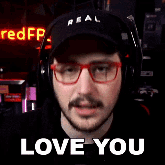 a man wearing glasses and headphones says " love you " in front of a red fp sign