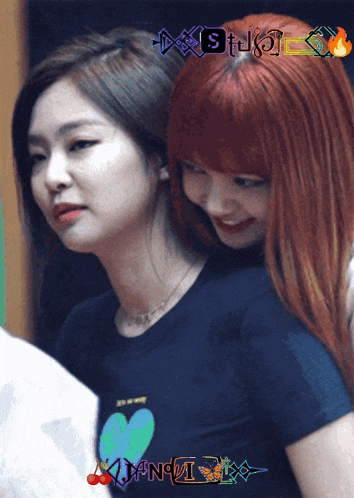 a girl with red hair is wearing a black shirt with a heart on it and the word studio on the bottom