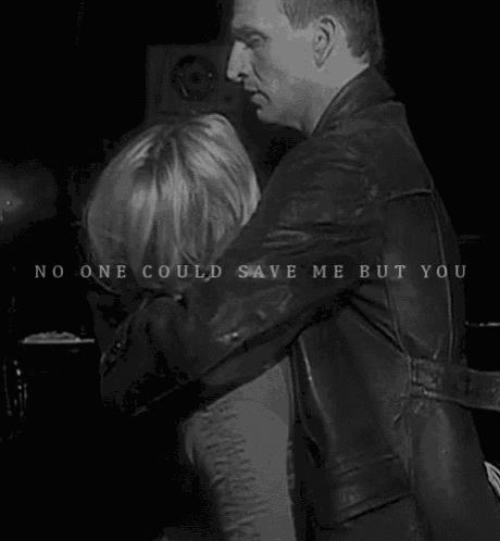a black and white photo of a man and woman hugging each other .