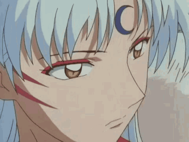 a close up of a person with a crescent moon on their forehead .