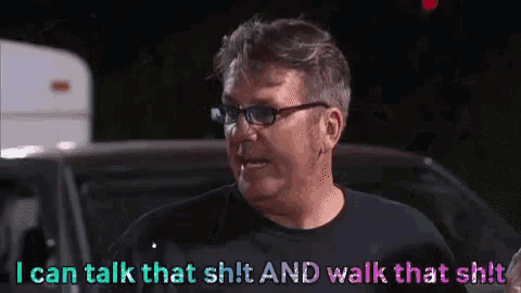 a man wearing glasses and a black shirt is saying i can talk that shit and walk that shit