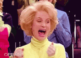 a woman in a yellow turtleneck is screaming with her mouth wide open