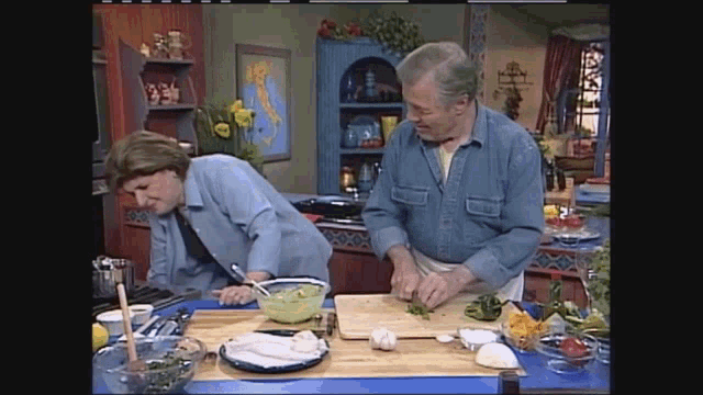 a man and a woman cooking in a kitchen