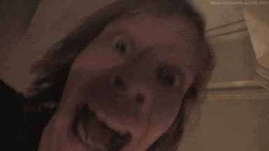 a blurry picture of a person standing in a dark room with a blurred background .