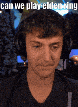 a man wearing headphones with the caption " can we play elden ring " on the bottom