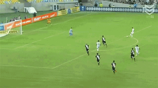 a soccer game is being played on a field with advertisements for quartzolit on the sidelines