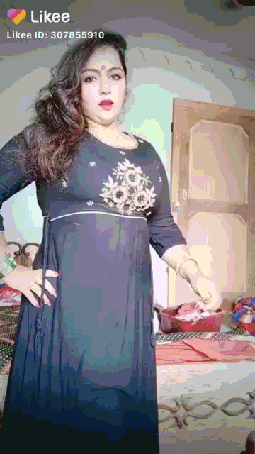 a woman in a black dress is standing in front of a door with likee written on the bottom