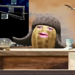 a peanut with a face on it is sitting at a table