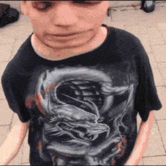 a man wearing a black shirt with a dragon on it