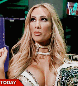 a woman in a very revealing outfit is holding a world heavyweight title
