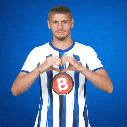 a man in a blue and white striped shirt with the letter b on the front