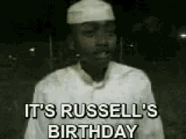 a man is wearing a white hat and a white shirt and says it 's russell 's birthday
