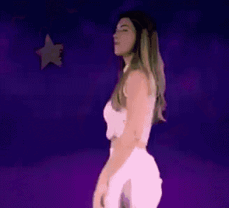 a woman in a white top and white pants is dancing in front of a purple background with a yellow star .
