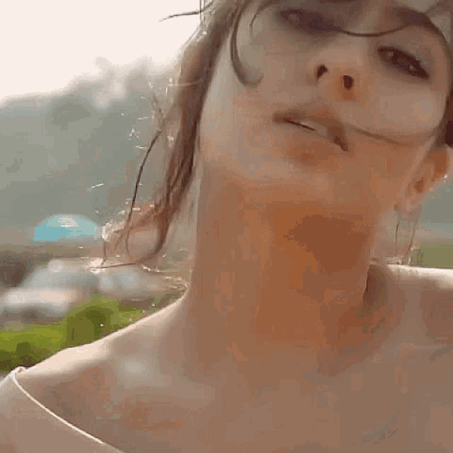 a close up of a woman 's face with her eyes closed