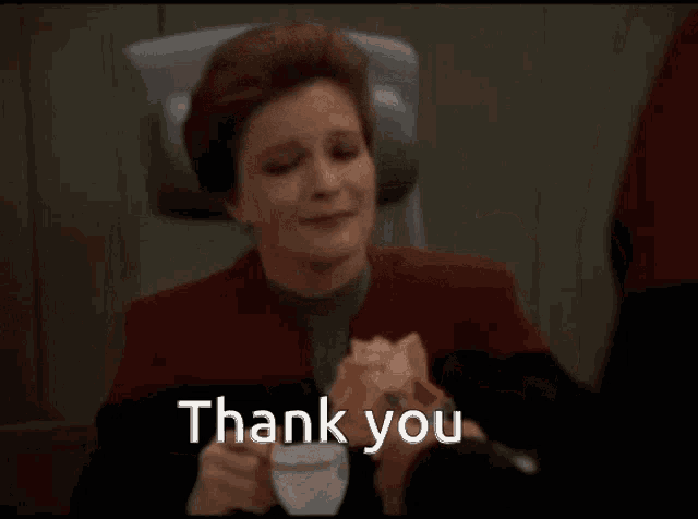 a woman holding a rose with the words thank you written below her