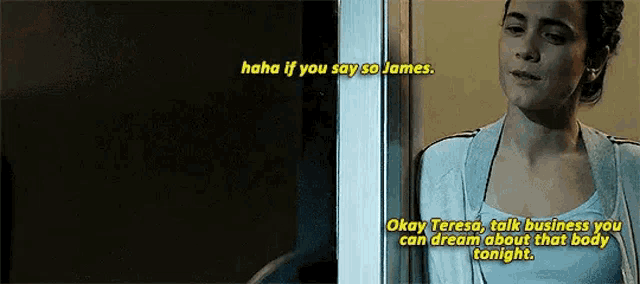 a woman is standing in a doorway talking to someone .