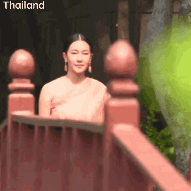 a blurred image of a woman with the word thailand on the bottom right