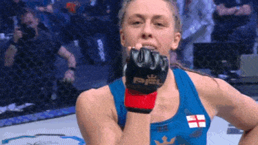 a woman wearing a blue tank top with a british flag on it