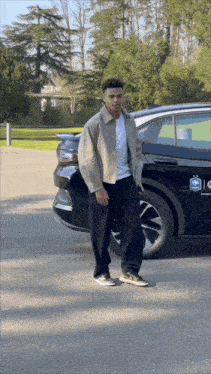 a man standing in front of a black car with a sticker on it that says ' hyundai ' on it