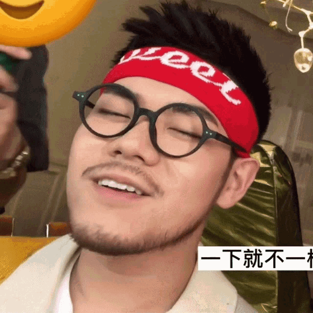 a man wearing glasses and a headband that says weet