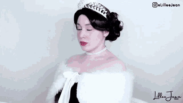 a woman wearing a tiara and a white fur cape has the name lillee jean on the bottom right