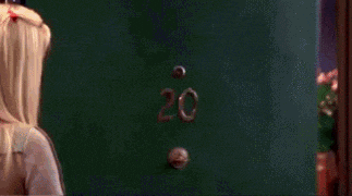 a woman standing in front of a door with the number 20 on it .