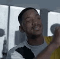 a man is smiling and dancing in a room .