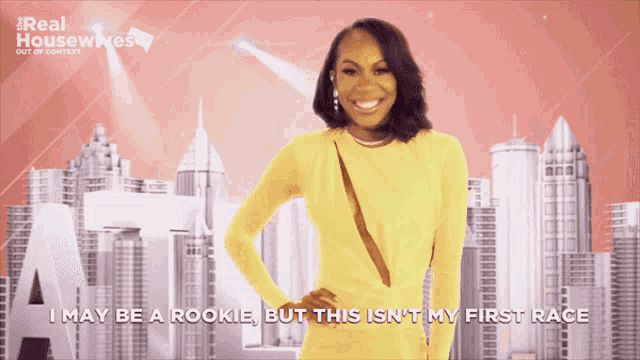 a woman in a yellow dress with the words i may be a rookie but this is n't my first race