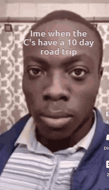 a man is making a funny face in front of a shower curtain while talking about a road trip .